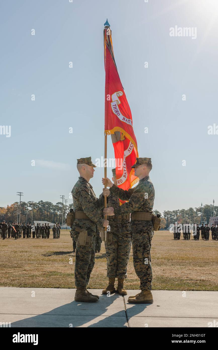 U.S. Marine Corps Lt. Col. John F. Campbell, the incoming commanding officer of 3rd Battalion, 2d Marine Regiment, 2d Marine Division, left, receives the colors from Lt. Col. Charles C. Nash, the outgoing commanding officer, during a change of command ceremony on Camp Lejeune, North Carolina, Dec. 2, 2022. Stock Photo
