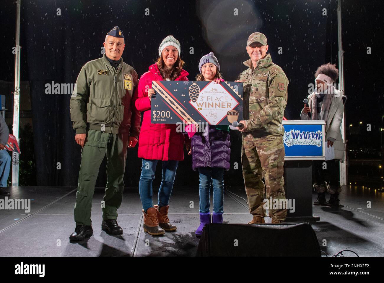 U.S. Air Force Brig. Gen. Tad Clark, 31st Fighter Wing commander, far right, and Italian Air Force Lt. Col. Riccardo Isoli, operations chief, far left, present the third place for the holiday card decoration contest prize to representatives from the 510th Fighter Squadron, middle, during the Wyvern Wonderland holiday event at Aviano Air Base, December 2, 2022. Wyvern Wonderland provided a host of events and activities to help families connect with each other and thrive during their time in Italy. Stock Photo