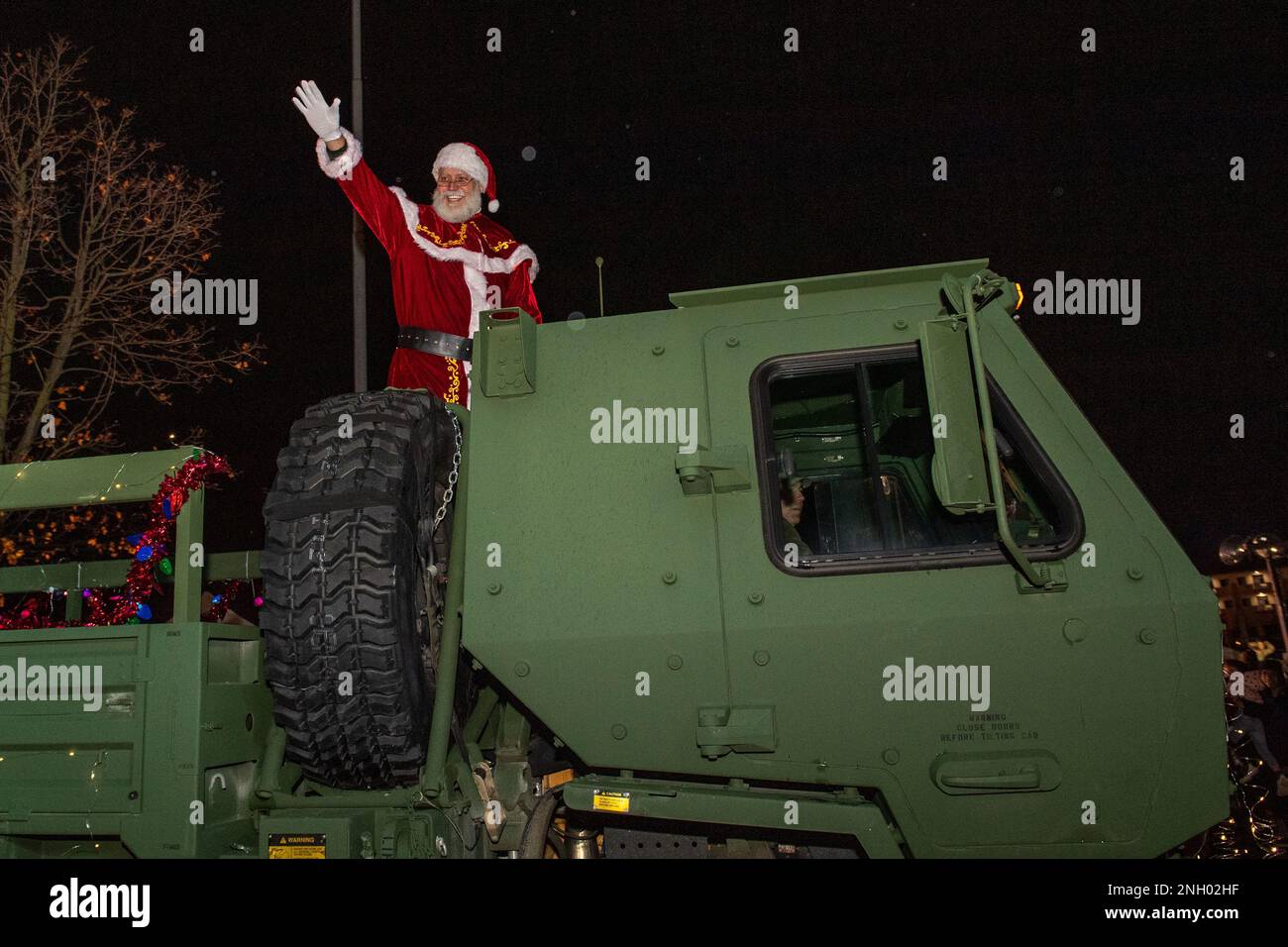 Santa Claus, North Pole gift-giver, waves to the crowd as he is escorted onto base during the Wyvern Wonderland holiday event at Aviano Air Base, December 2, 2022.Wyvern Wonderland provided a host of events and activities to help families connect with each other and thrive during their time in Italy. Stock Photo