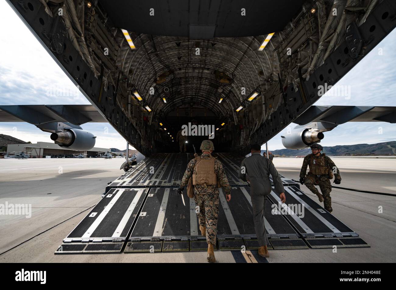 U.S. Marines with Battery Q, 5th Battalion, 11th Marine Regiment, and Airmen from the 21st Airlift Squadron board a C-17 Globemaster III during exercise Steel Knight, at Camp Pendleton, California, Dec. 2, 2022. The 21st AS transported 15 Marines and approximately 68,000 pounds of equipment during their annual exercise which included live-fire training in controlled environments. Stock Photo