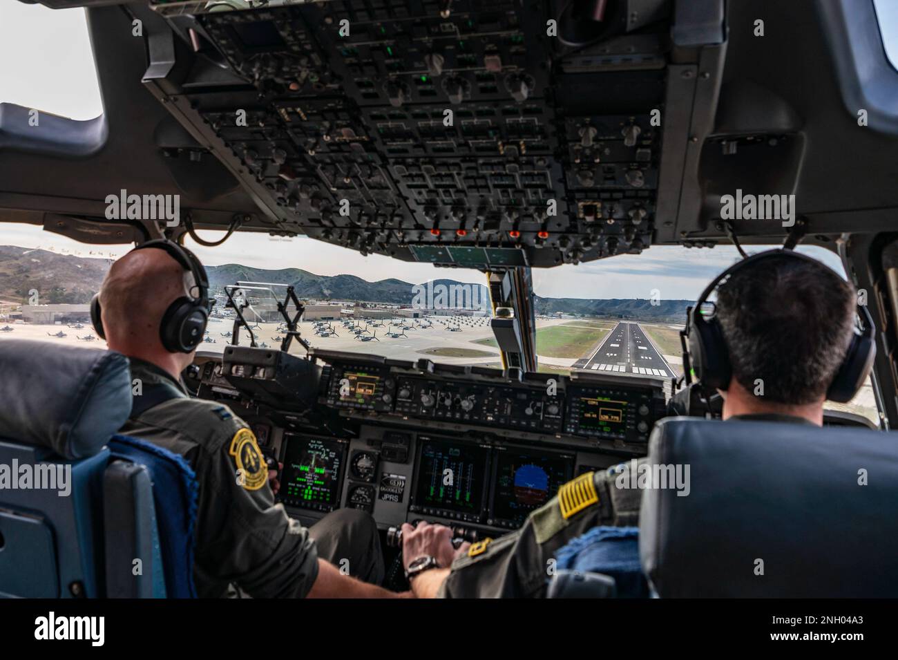 U.S. Air Force Capt. Matthew Krussow, left, and Capt. Hunter Gillon, both 21st Airlift Squadron C-17 Globemaster III pilots, descend for landing at Camp Pendleton, California, during exercise Steel Knight, Dec. 2, 2022. The 21st AS transported 15 Marines and approximately 68,000 pounds of equipment during their annual exercise which included live-fire training in controlled environments. Stock Photo