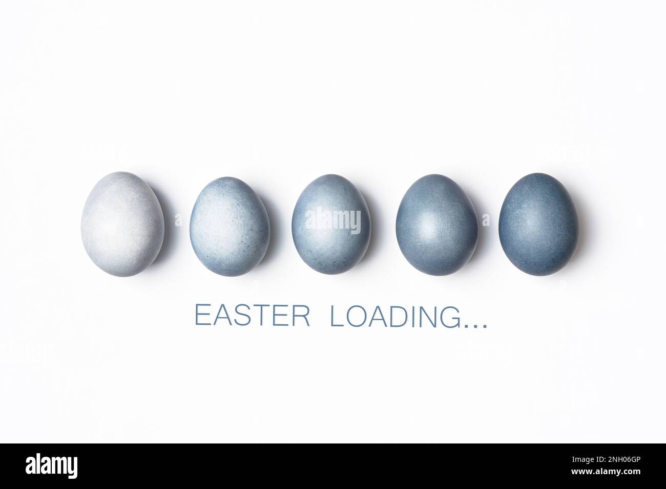 Dyed blue gradient Easter eggs row on white. Easter loading concept. Creative greeting card, minimal. Stock Photo