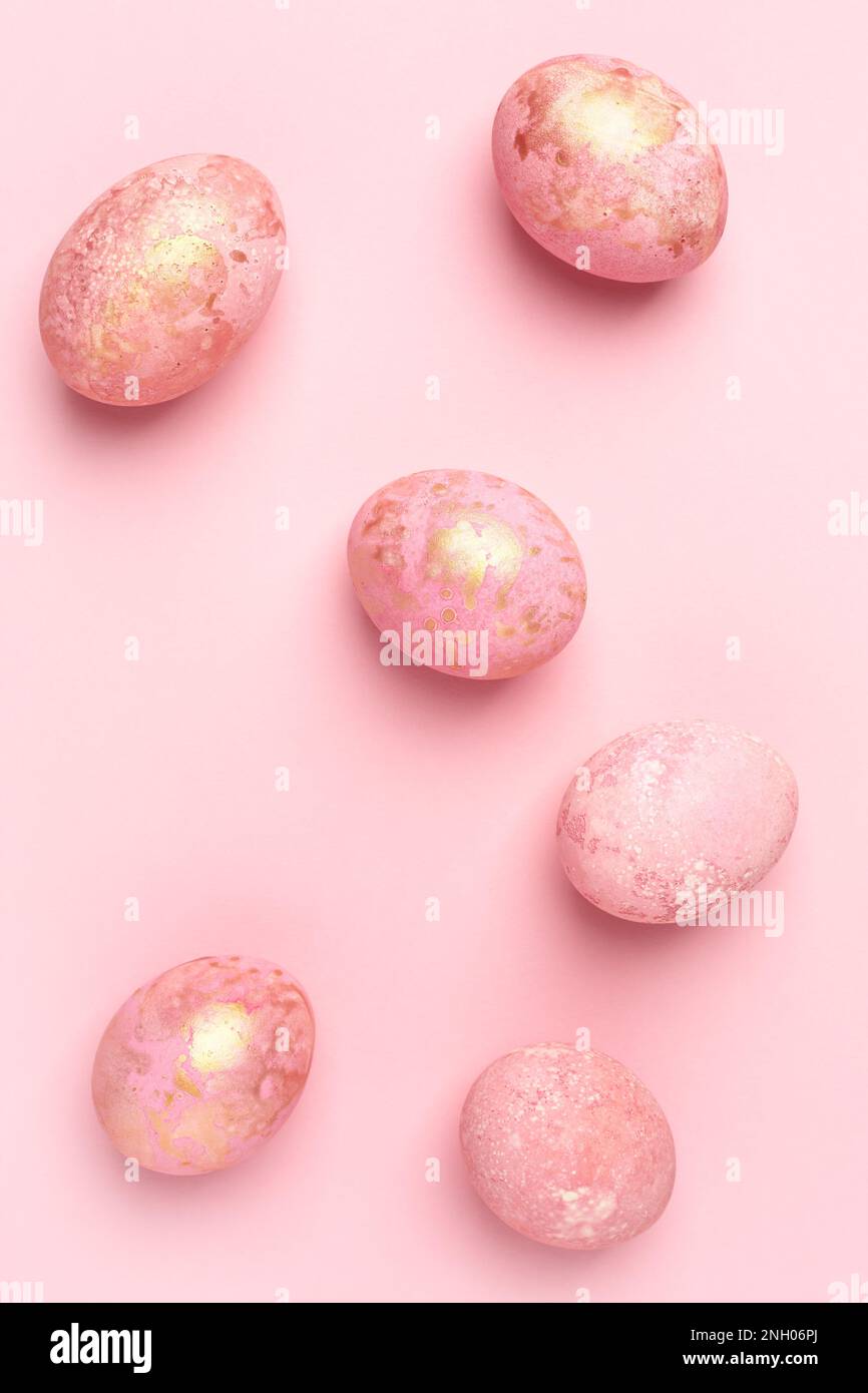 Pink Easter eggs, pastel Easter background. Monochrome greeting card, flat lay. Stock Photo