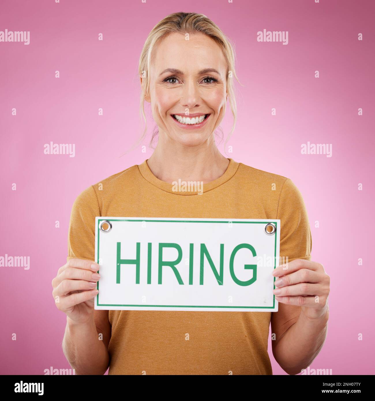 Woman, hiring sign and studio portrait, announcement or human resources
