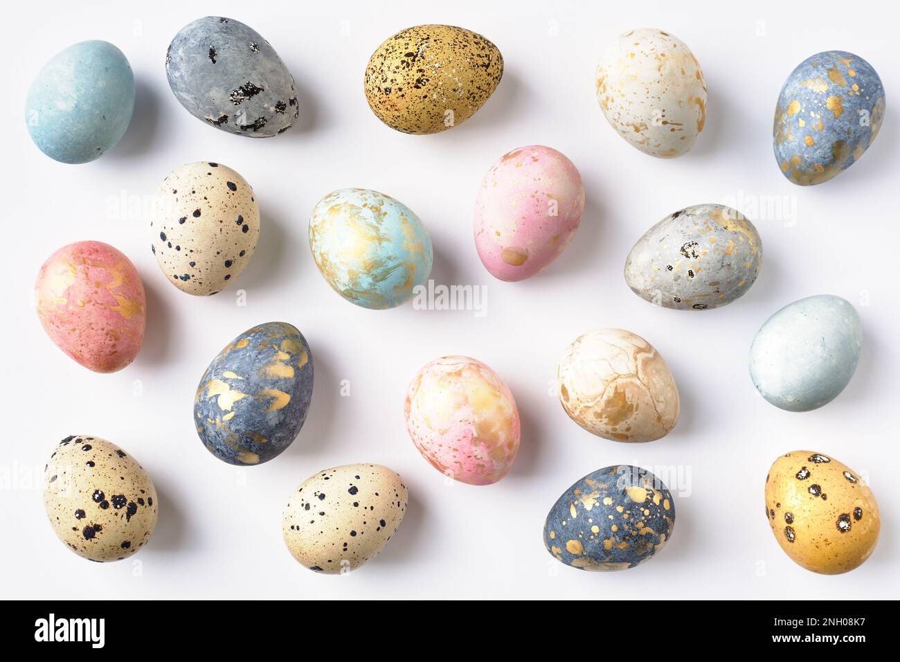Dyed colorful pastel Easter eggs pattern on white background. Easter greeting card. Stock Photo