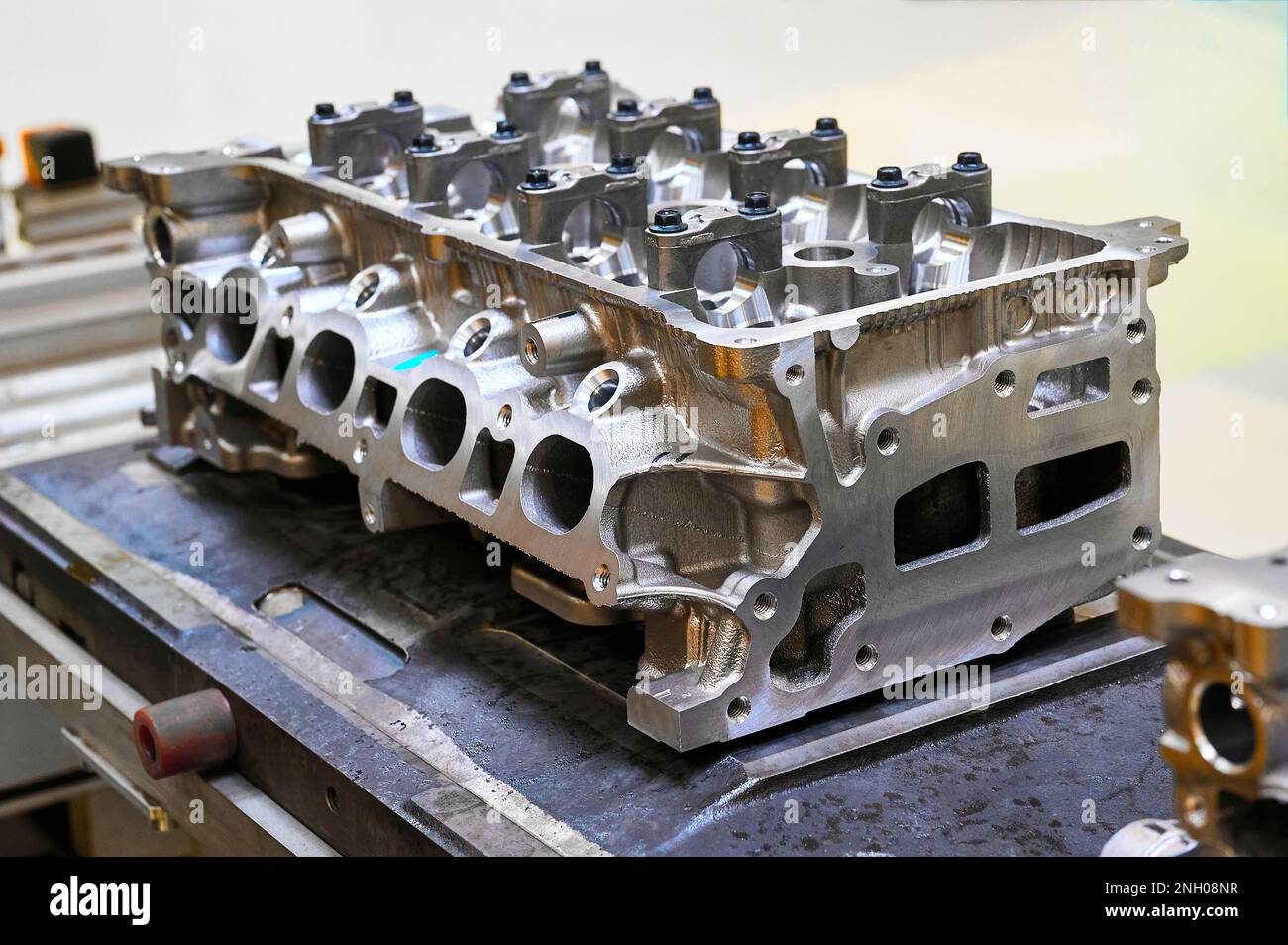Car engine cylinder heads in housings on conveyor in shop Stock Photo