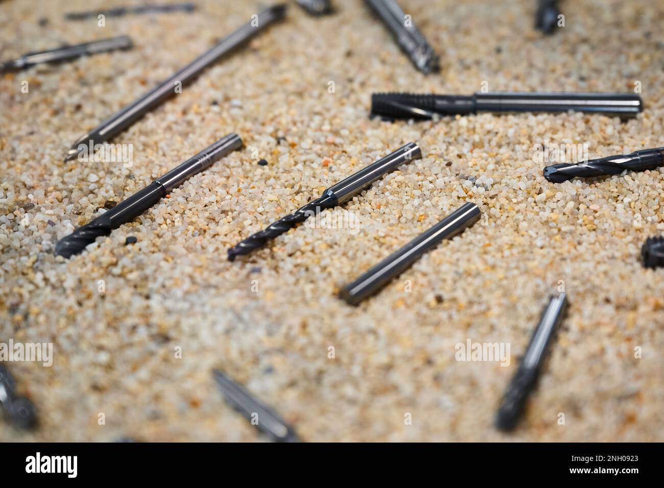 Different drilling tools on sand surface in Stock Photo Alamy