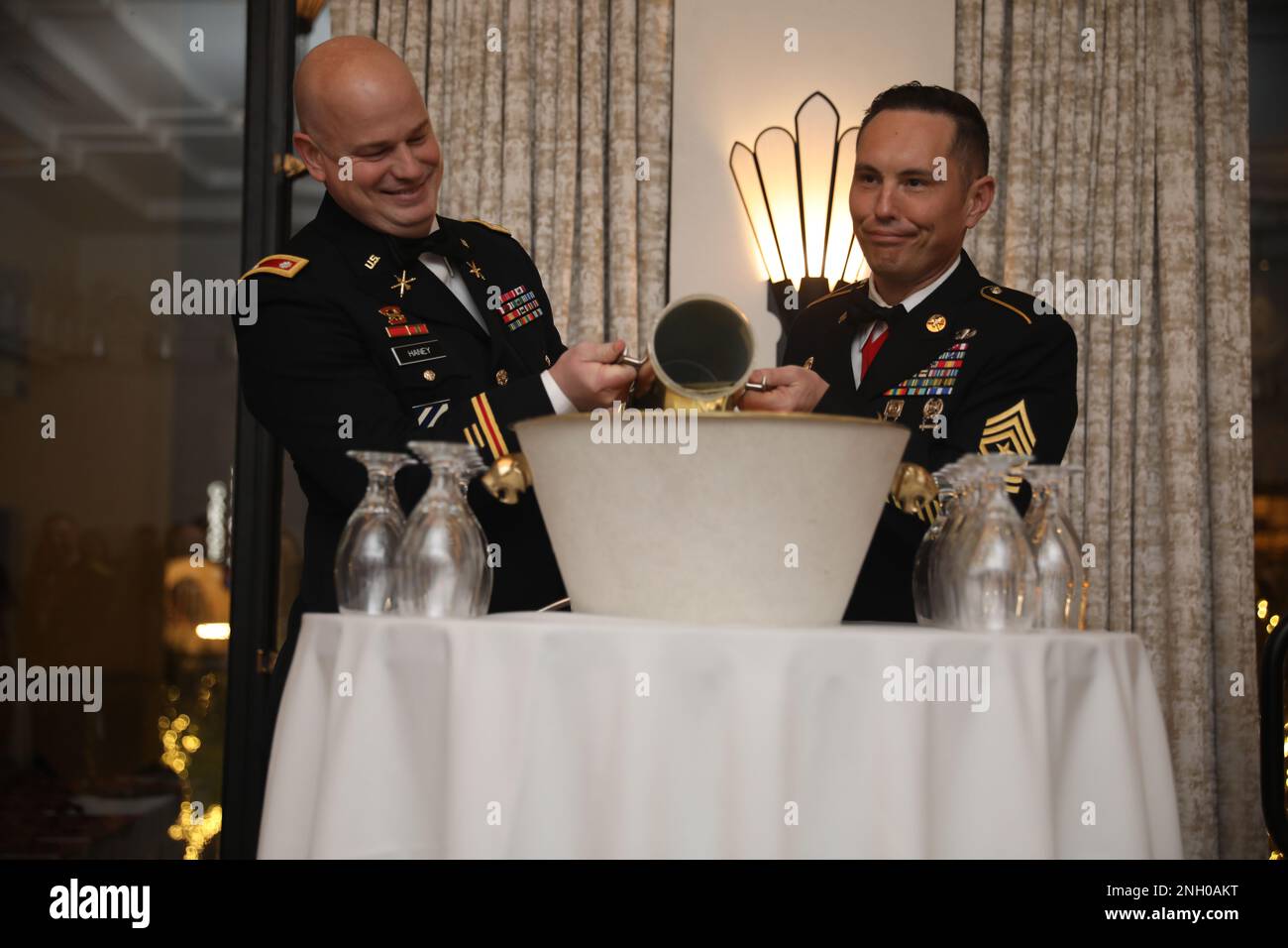 The 108th Air Defense Artillery Brigade command team contributes a charge to the ceremonial grog during the Saint Barbara's Social, December 3rd at the Plaza Hotel in El Paso, Texas. Stock Photo