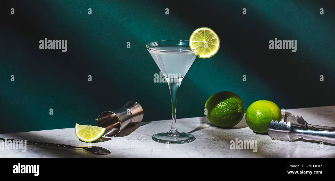 Vodka gimlet alcoholic cocktail drink with vodka, syrup, lime juice and ice, dark green