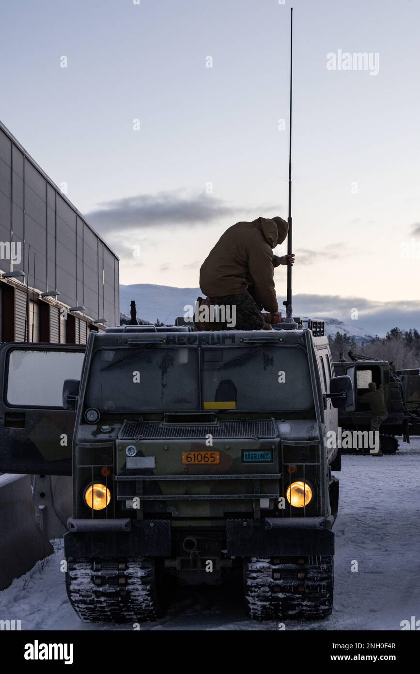 U.S. Marine Corps Sgt. Michael Karman, a telecommunications system information repair technician with Communications Company, Headquarters Battalion, 2d Marine Division, installs communications equipment on a Bandvagn 206 tracked vehicle in Setermoen, Norway on Dec. 4, 2022. This communications upgrade enables U.S. Forces to better communicate during operations and exercises as well as set the groundwork for advanced communications capabilities with NATO Allies in the future. Stock Photo
