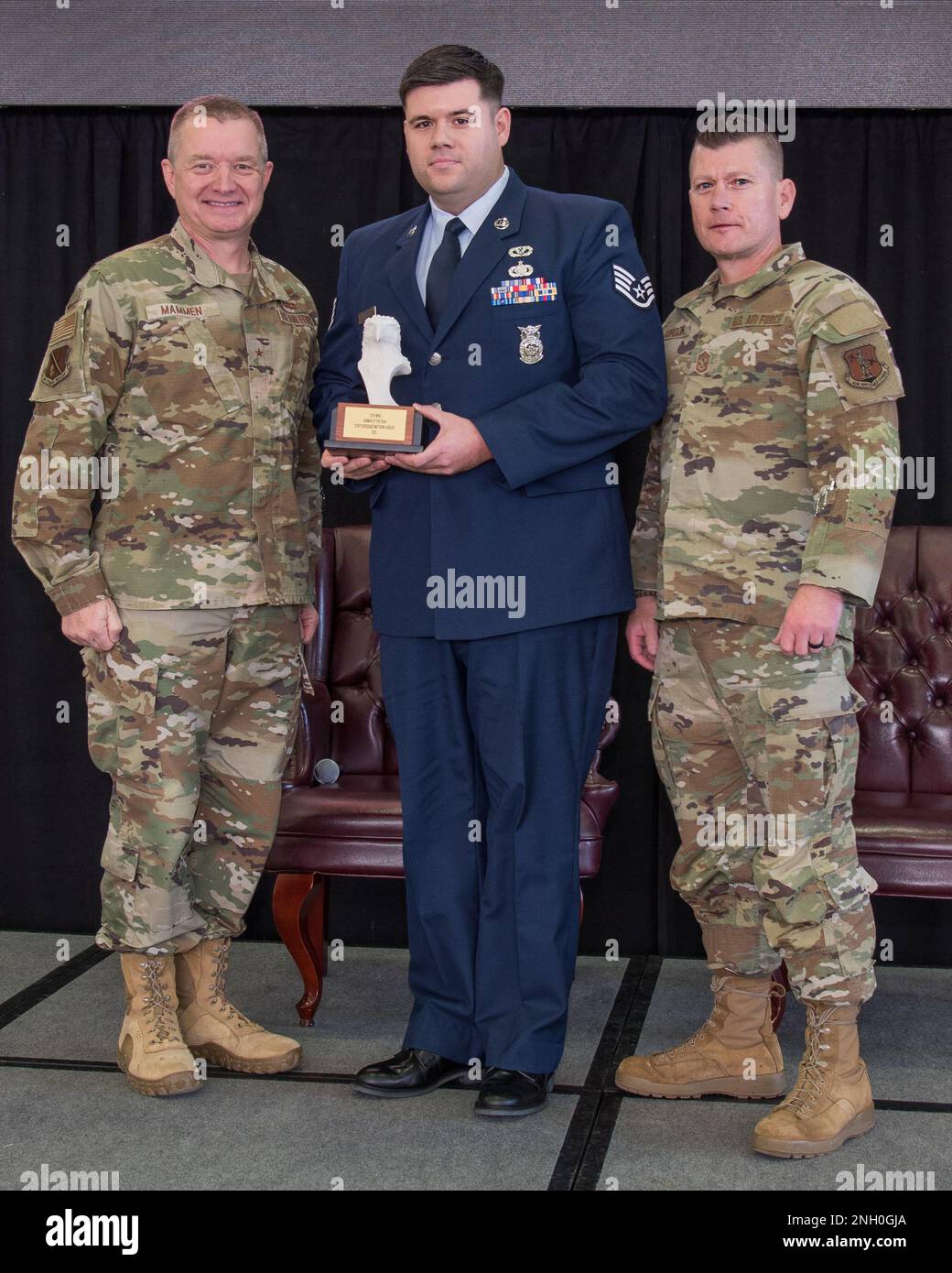 Brig. Gen. Rolf Mammen, 127th Wing Commander, Staff Sgt. Matthew Jarecki, firefighter, 127th Civil Engineer Squadron and Chief Master Sgt. Rick Gordon, 127th Wing command chief, based in Selfridge Air National Guard Base, Michigan, pose after awarding Jarecki the Wing’s outstanding airman of the year award. Jarecki and seven other individuals were awarded in different categories and will advance to the Michigan Air National Guard competition. Stock Photo