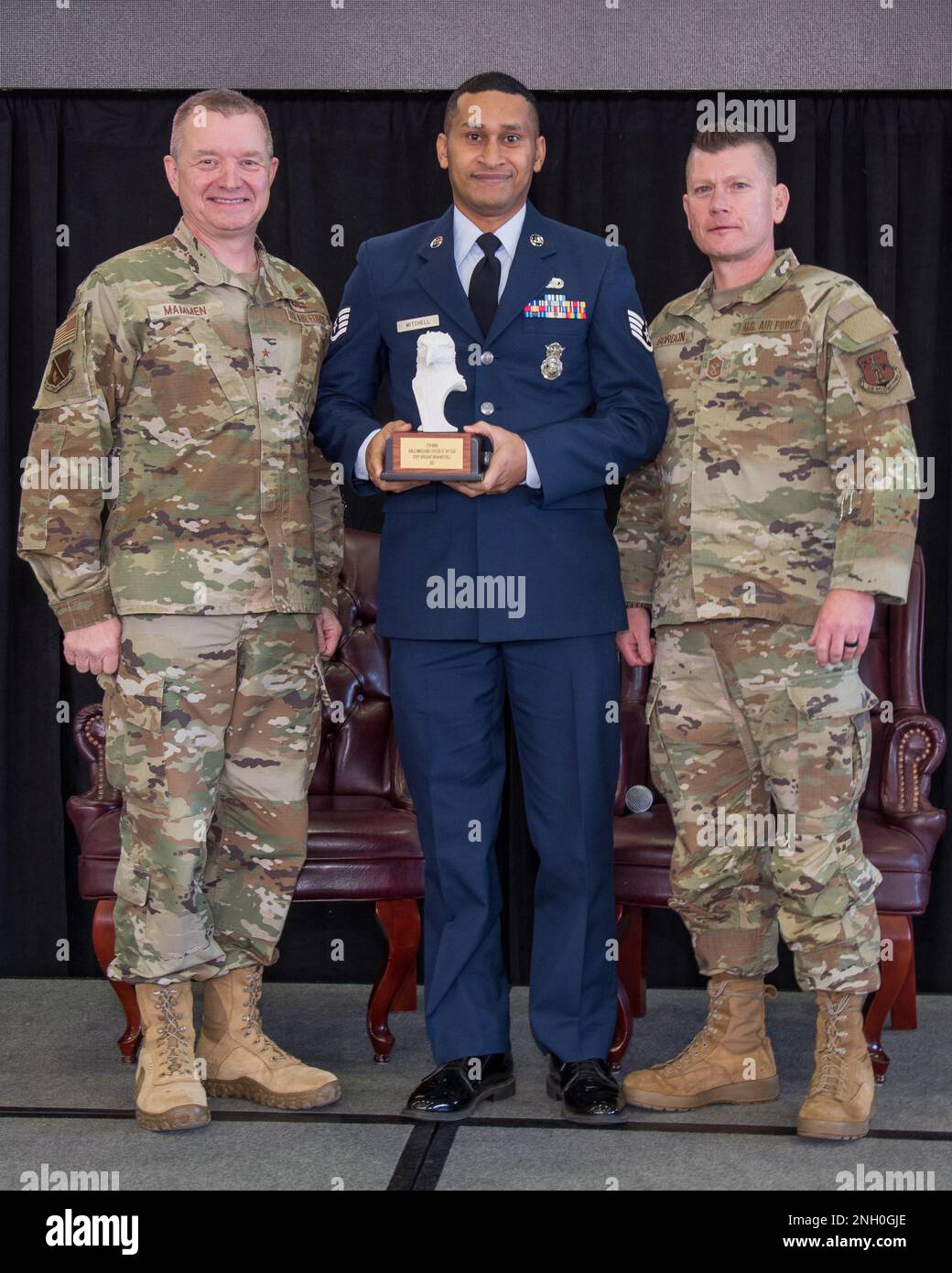 Brig. Gen. Rolf Mammen, 127th Wing commander, Staff Sgt. Brian Mitchell, defender, 127th Security Forces Squadron and Chief Master Sgt. Rick Gordon, 127th Wing command chief, based in Selfridge Air National Guard Base, Michigan, pose after awarding Mitchell the Wing’s outstanding non-commissioned officer of the year award. Mitchell and seven other individuals were awarded in different categories based on rank and will advance to the Michigan Air National Guard competition. Stock Photo