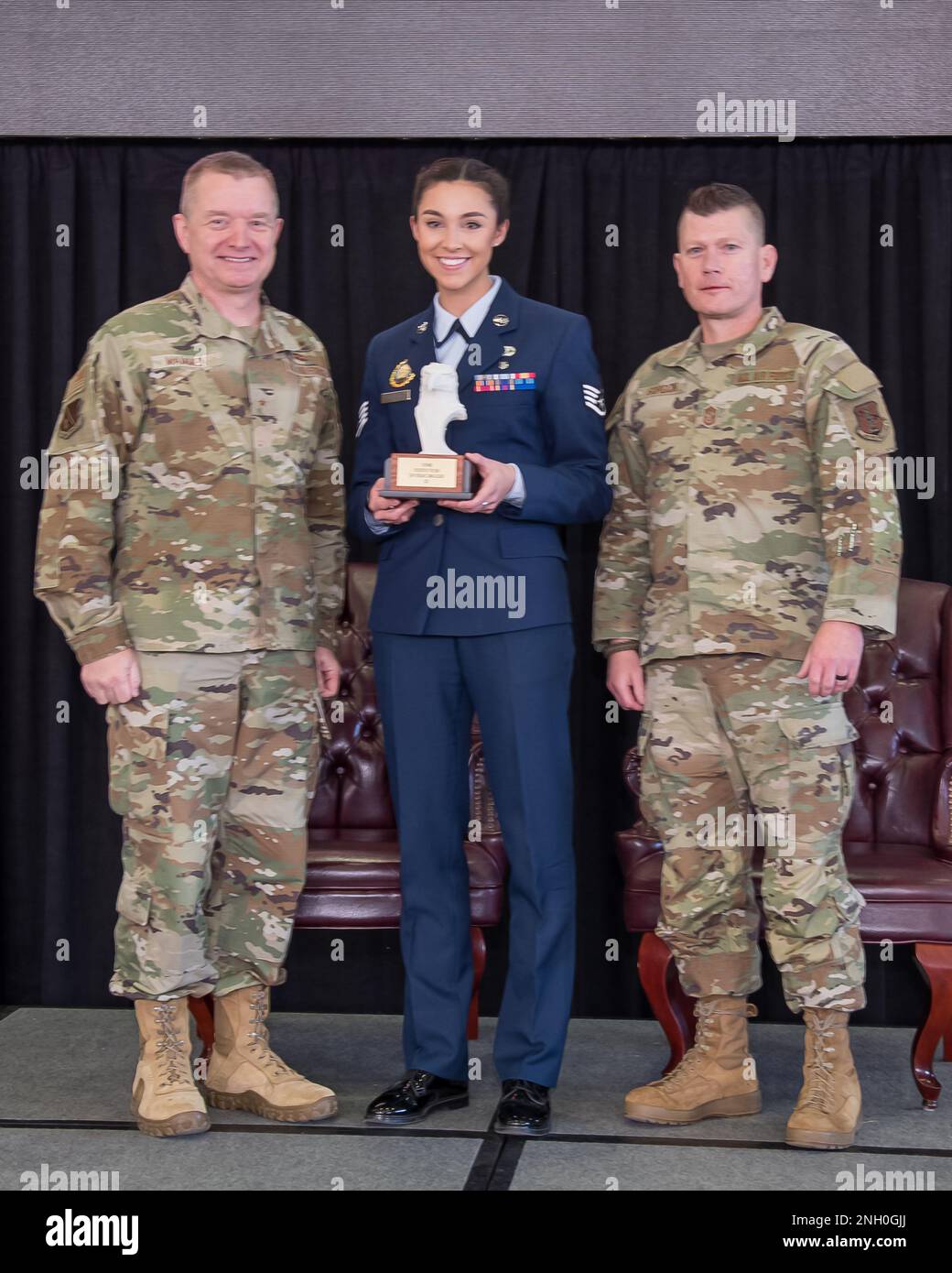 Brig. Gen. Rolf Mammen, 127th Wing Commander, Staff Sgt. Jenna Gleason, recruiter, 127th Mission Support Group and Chief Master Sgt. Rick Gordon, 127th Wing command chief, based in Selfridge Air National Guard Base, Michigan, pose after awarding Gleason the Wing’s outstanding recruiter of the year award. Gleason and seven other individuals were awarded in different categories and will advance to the Michigan Air National Guard competition. Stock Photo