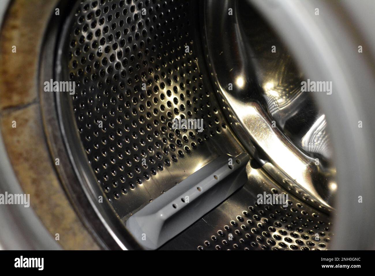 Stainless steel washing machine drum with an open door of the washer
