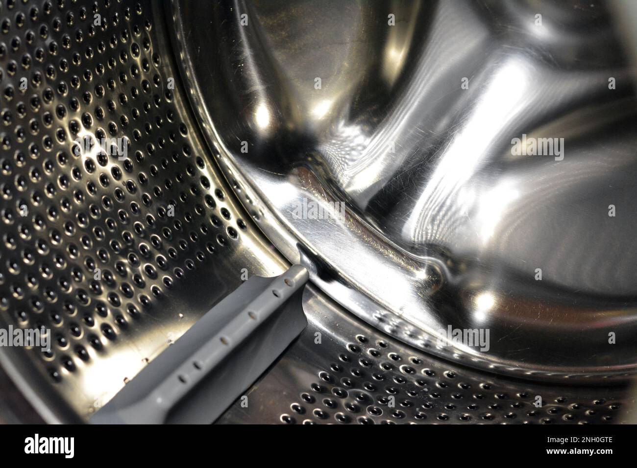 Stainless steel washing machine drum with an open door of the washer