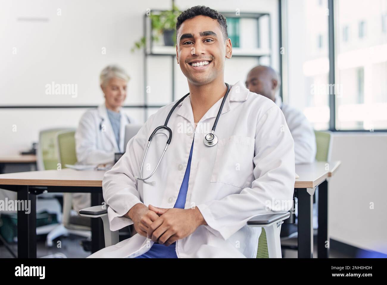 Young doctor, man and portrait at hospital desk with smile for ...