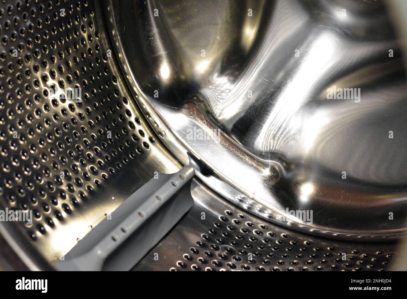 Stainless steel washing machine drum with an open door of the washer, washing machine