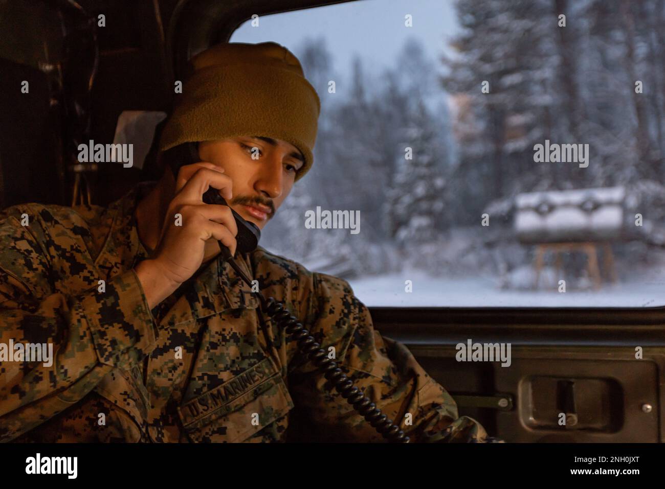 U.S. Marine Corps Pfc. Paul Speers, a telephone systems/personal computer repairer with Communications Company, Headquarters Battalion, 2d Marine Division, performs communications checks on equipment installed in a Bandvagn 206 vehicle in Setermoen, Norway on Dec. 5, 2022. This communications upgrade enables U.S. Forces to better communicate during operations and exercises as well as set the groundwork for advanced communications capabilities with NATO Allies in the future. Stock Photo