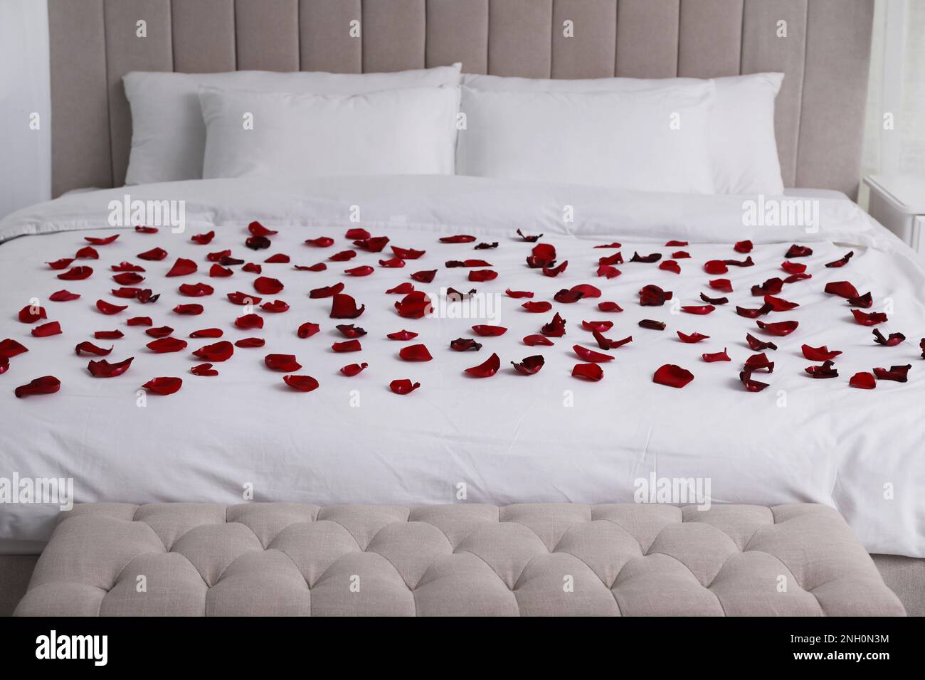 Beautiful red rose petals on bed in room Stock Photo Alamy