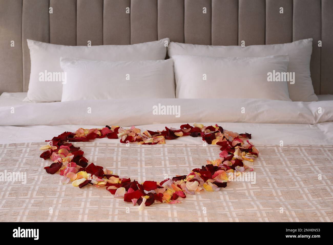 Beautiful heart of rose petals on bed Stock Photo Alamy