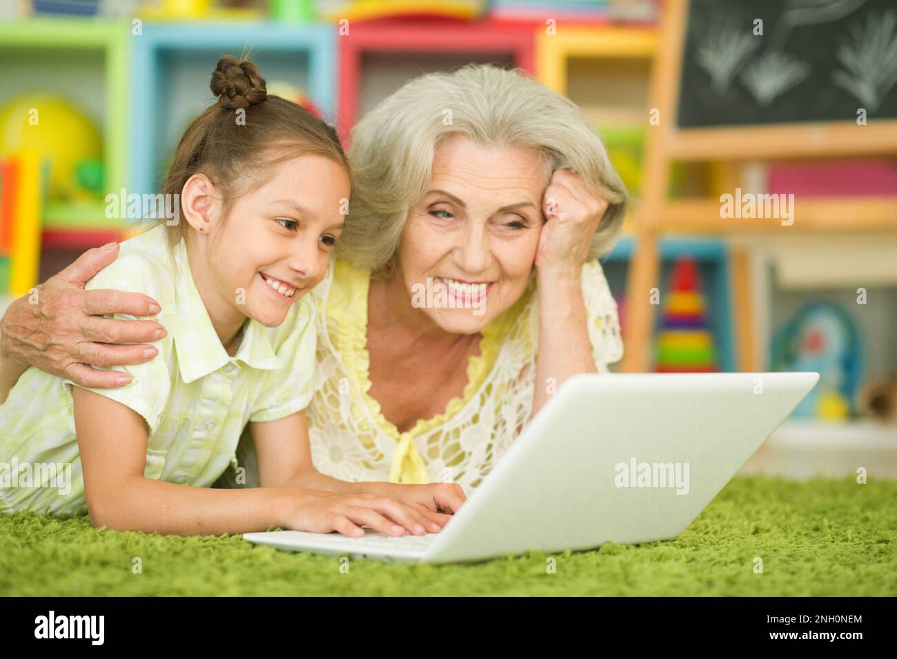 happy grandmother and granddaughter using laptop Stock Photo - Alamy