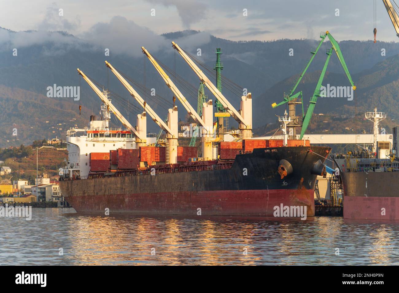 Cargo freight ship in industrial port. Logistics, import and export commerce, international transportation concept. Stock Photo