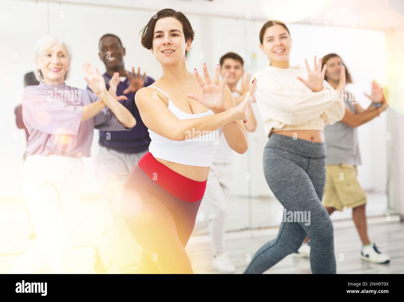 Young Hispanic woman practicing vigorous dance movements Stock Photo