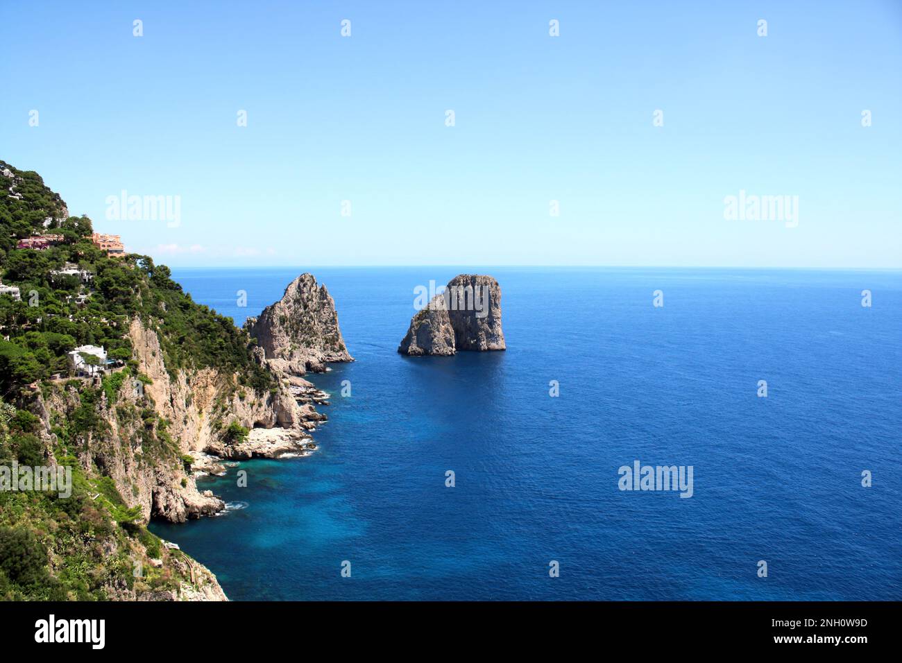 Top view on famous Faraglioni Rocks, Capri Island, Italy. Aerial view of beautiful landscape with azure sea, Capri island coastline and Faraglioni cli Stock Photo