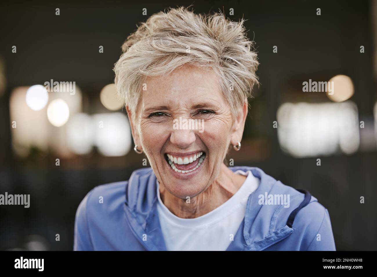 Fitness, smile and portrait of old woman in gym for workout, health and exercise goals. Happy, training and wellness with face of senior lady laughing Stock Photo