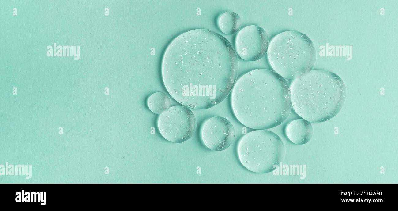 Cosmetic lotion transparent gel drops texture background, green Stock Photo