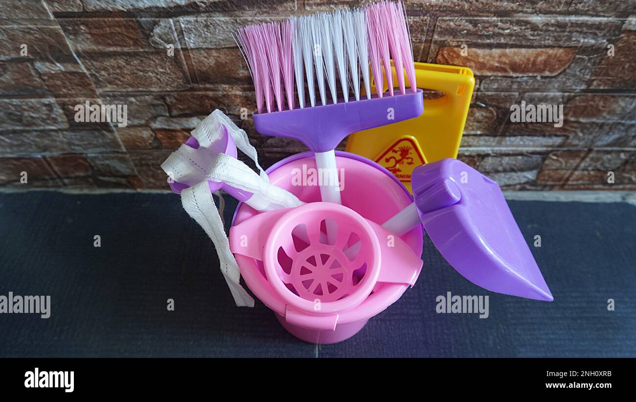 Children's games cleaning tools toy with warning wet signs as a means of educational games Stock Photo