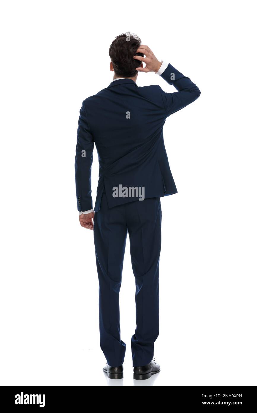 attractive businessman scratching head and pondering, wearing a suit and tie against white background Stock Photo