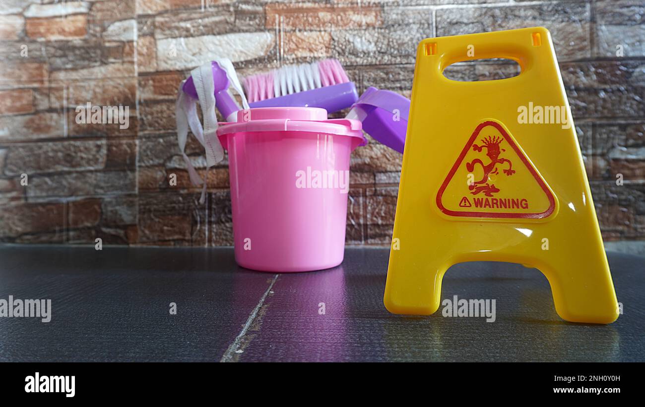 Children's games cleaning tools toy with warning wet signs as a means of educational games Stock