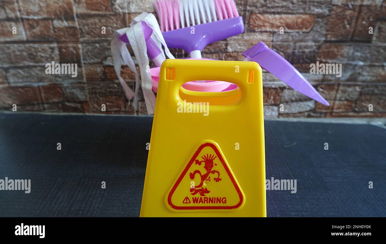 Children's games cleaning tools toy with warning wet signs as a means of educational games Stock Photo