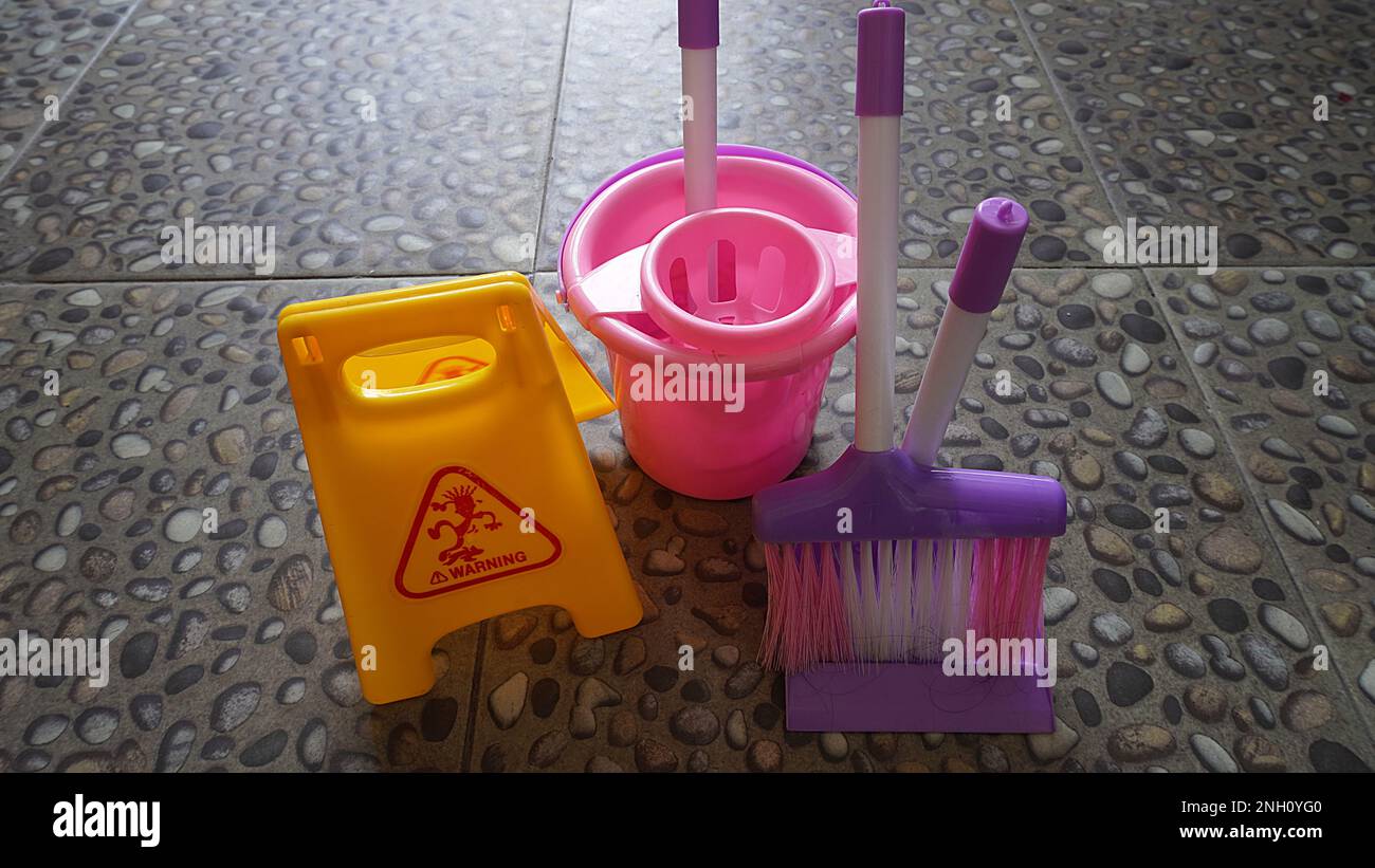 Children's games cleaning tools toy with warning wet signs as a means of educational games Stock Photo