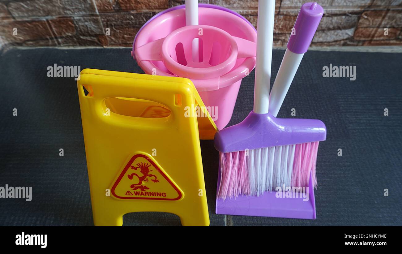 Children's games cleaning tools toy with warning wet signs as a means of educational games Stock Photo