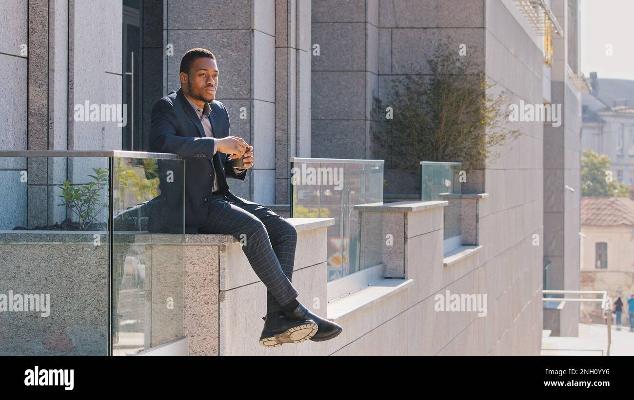 African man sitting in suit hi-res stock photography and images - Alamy