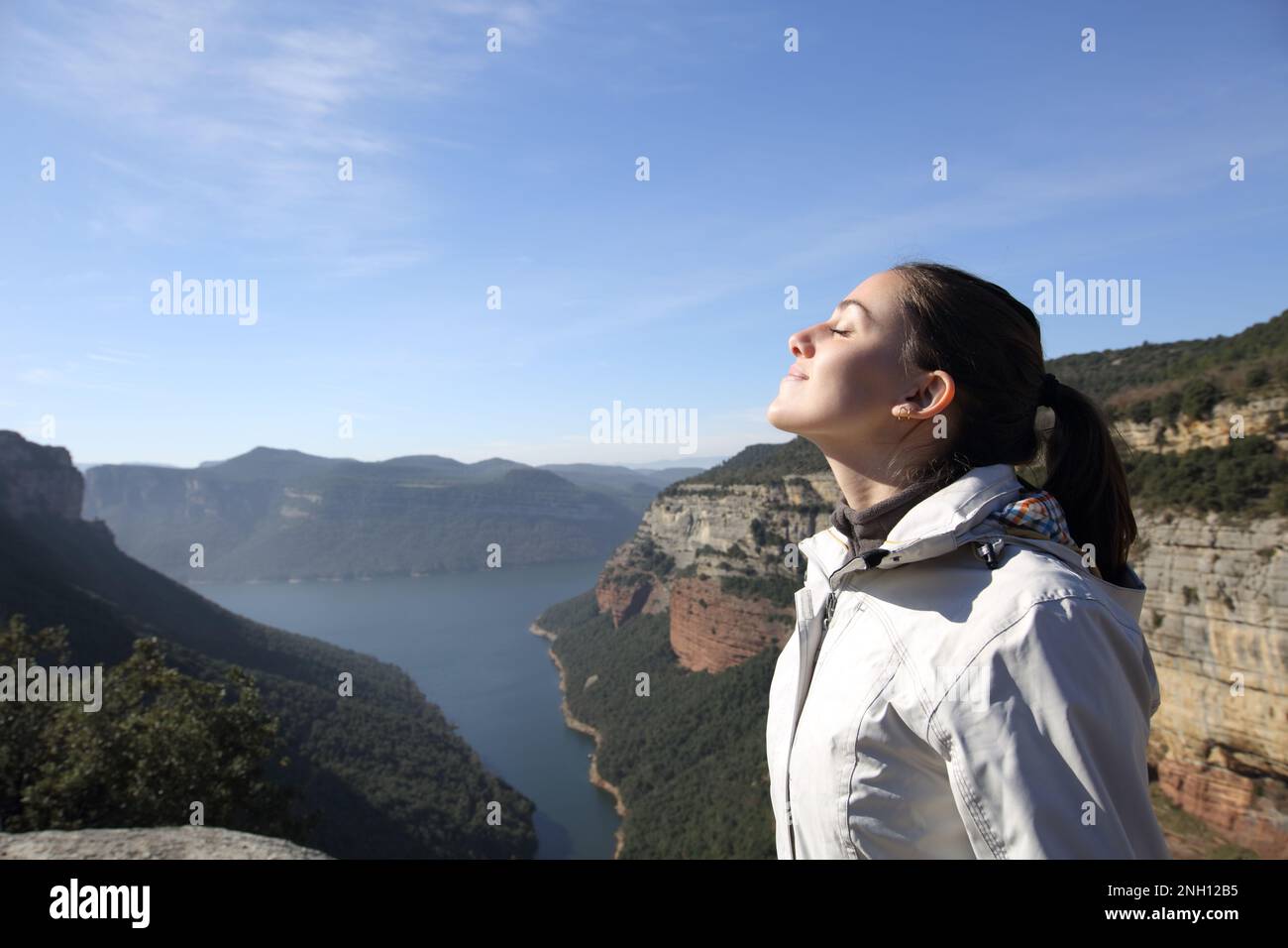 Profile of a hiker breathing in a landscape Stock Photo