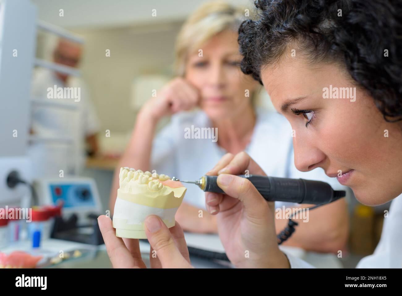 female dental technician working with implant mold Stock Photo Alamy