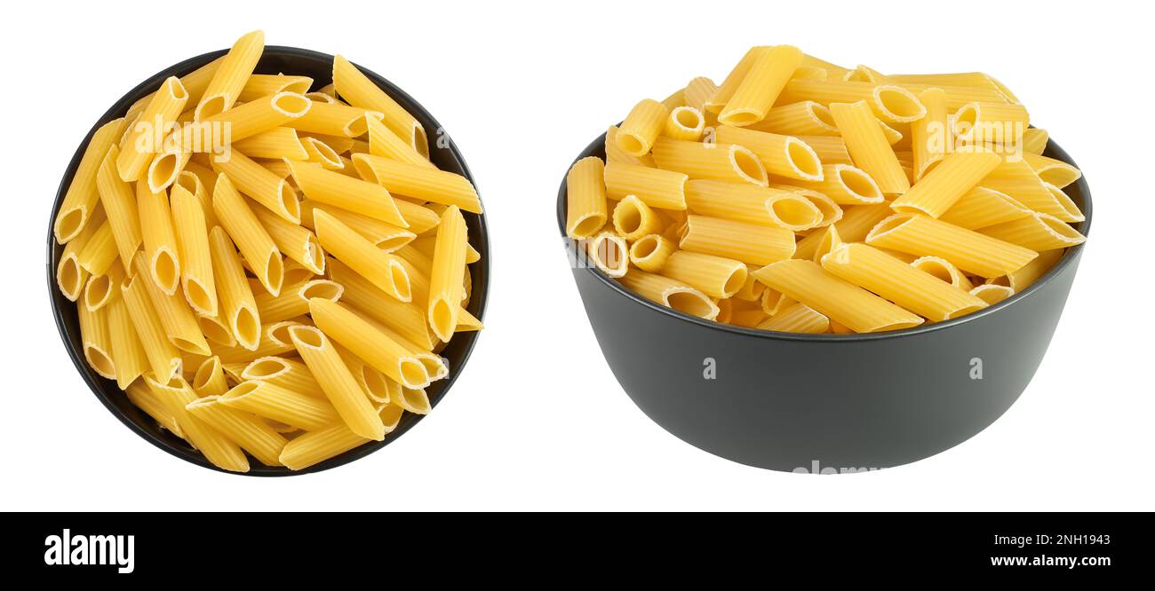 Raw italian penne rigate pasta in black bowl isolated on white background with full depth of field. Top view. Flat lay Stock Photo