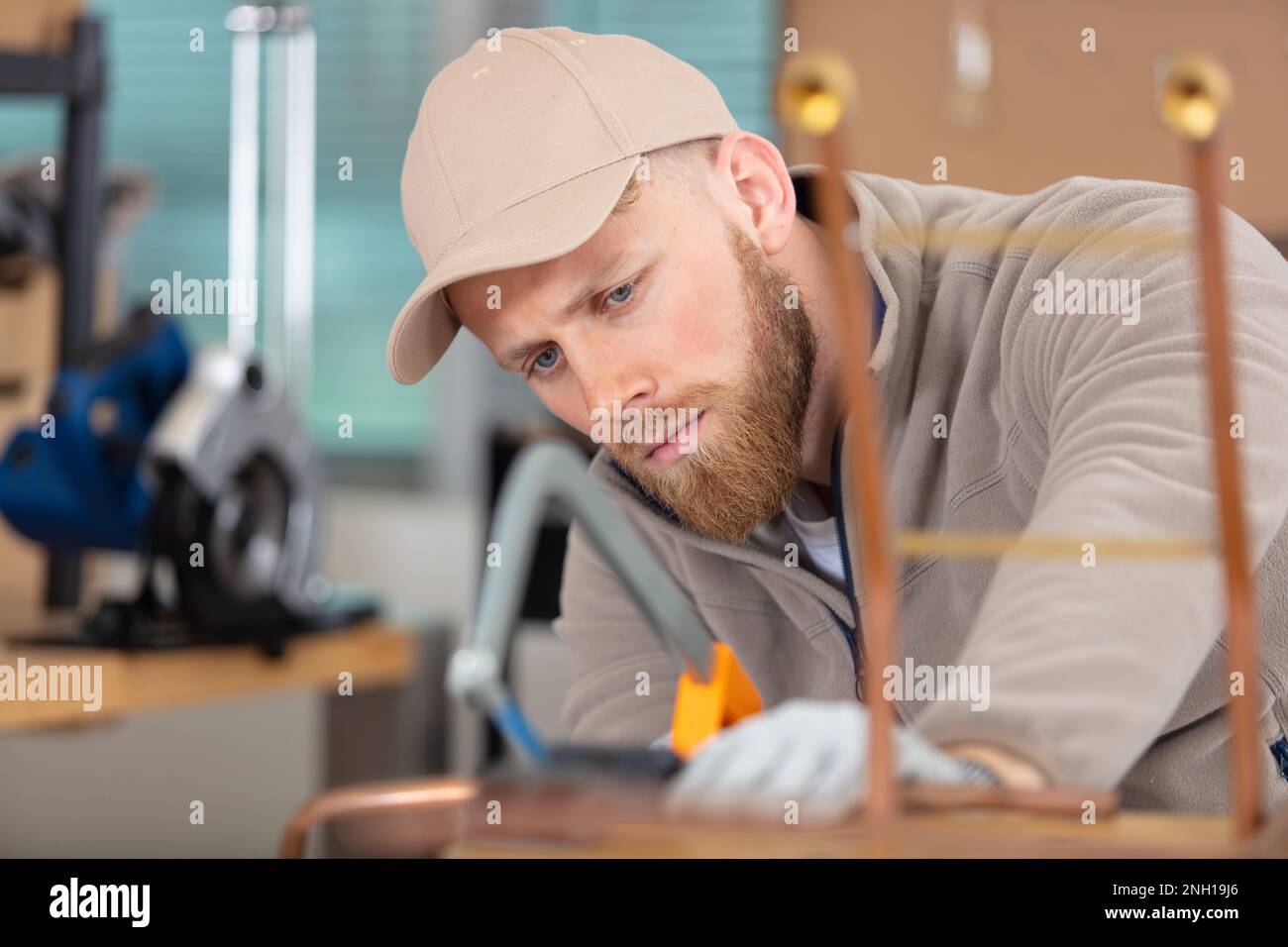 young man working on copper pipes Stock Photo