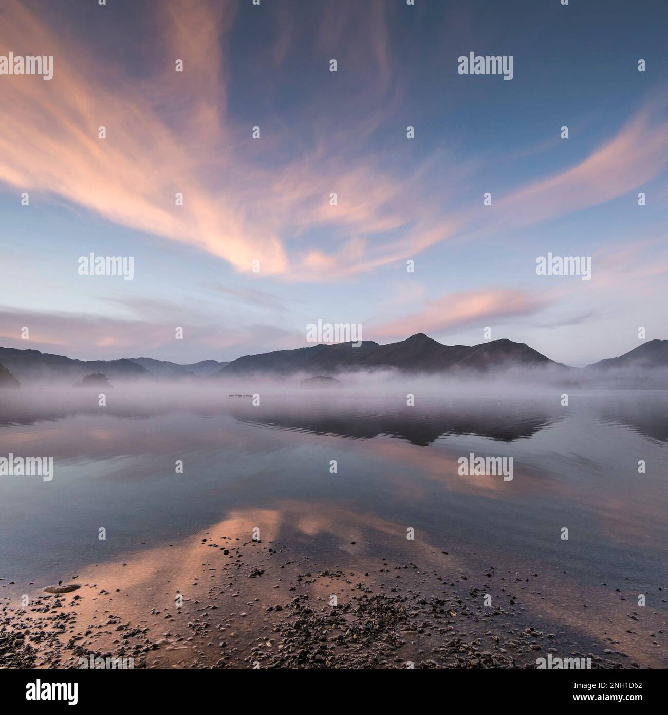 Square image of spring dawn sky reflected in Derwentwater near Stock Photo