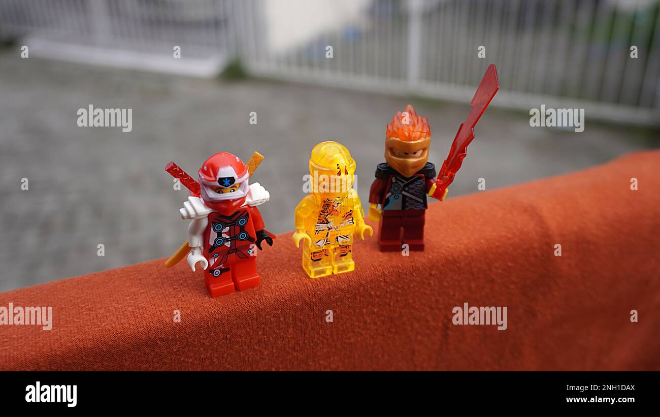 Surabaya, East Java, Indonesia - January, 2023 : Close up Lego toy game Ninja Go with bright clear sky and rooftop background Stock Photo