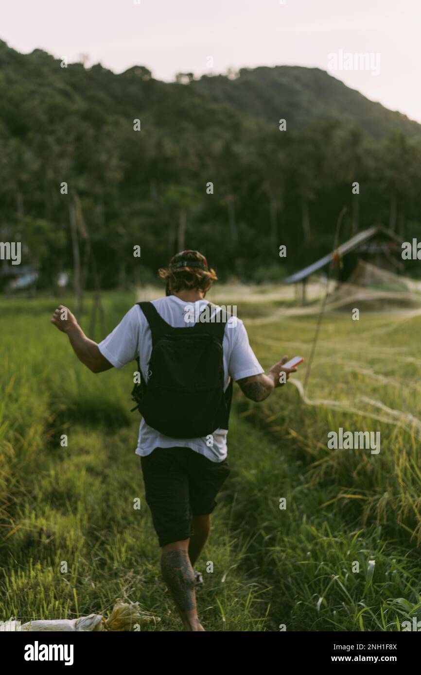 A young man in a rice field Stock Photo - Alamy