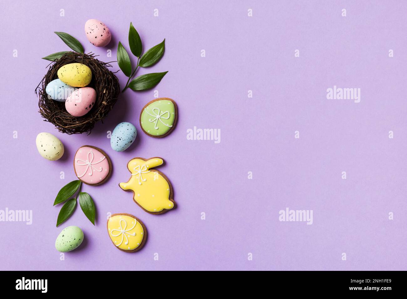 Colorful easter eggs in nest on table background with copy space top ...