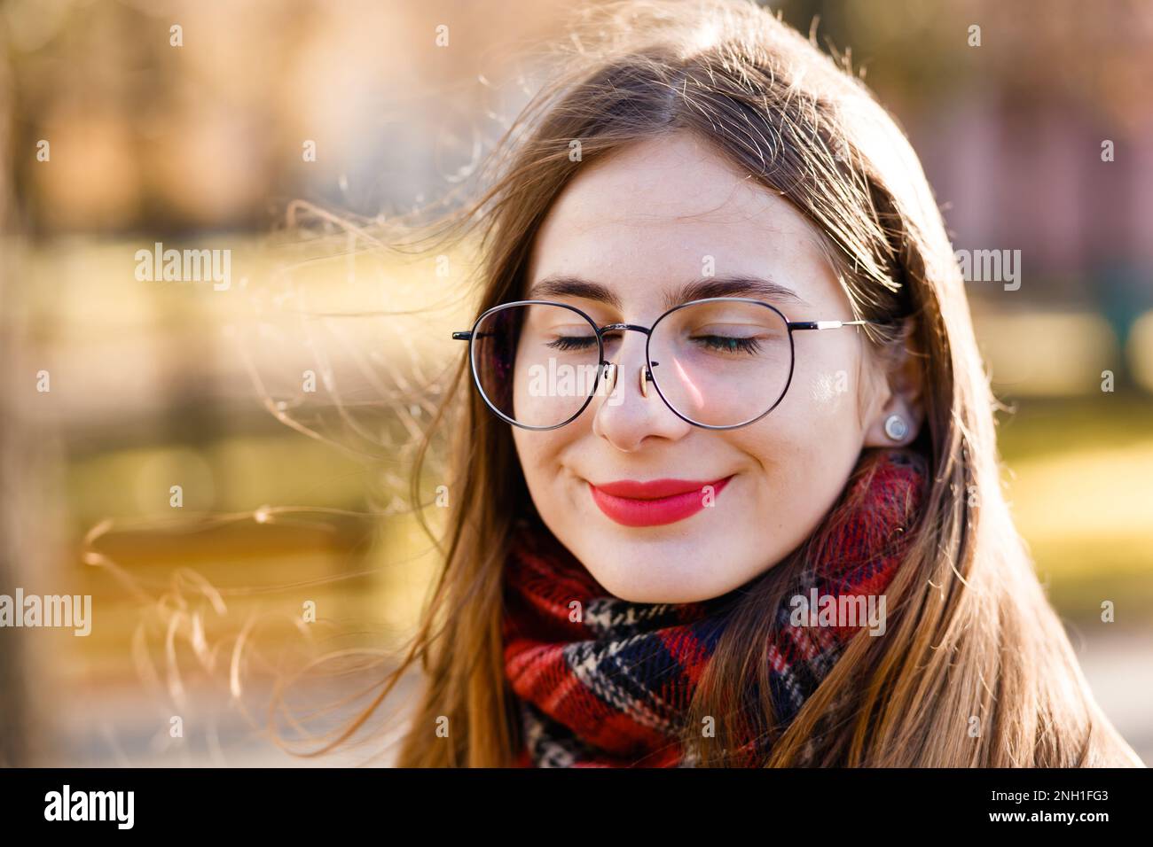 young woman in glasses wrapped in a scarf Stock Photo