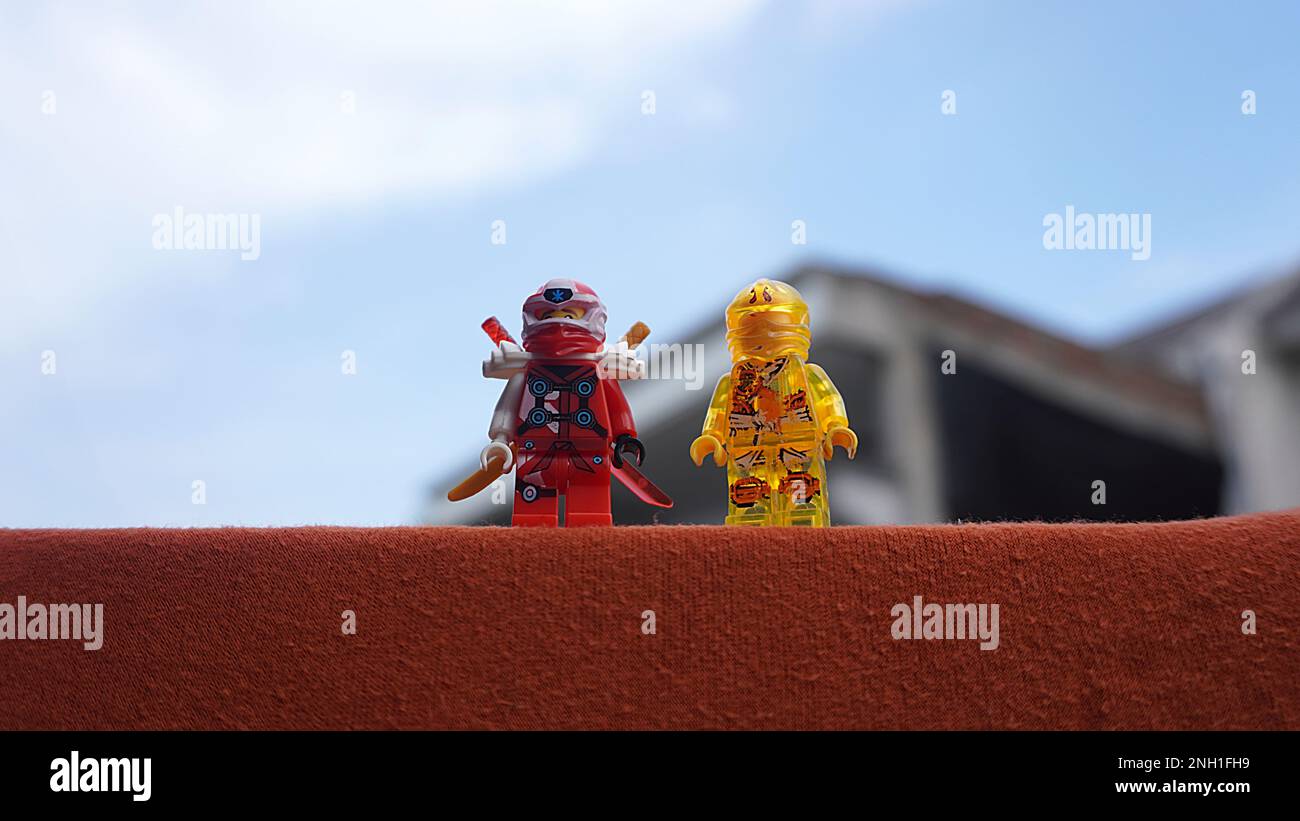 Surabaya, East Java, Indonesia - January, 2023 : Close up Lego toy game Ninja Go with bright clear sky and rooftop background Stock Photo