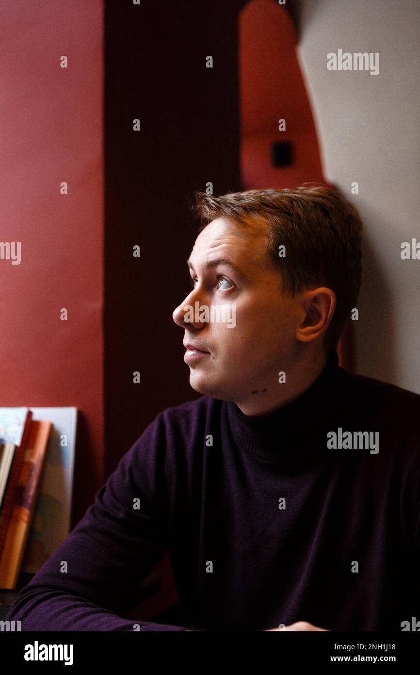 young man sits alone at cafe Stock Photo