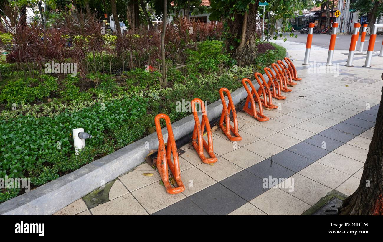 portable bicycle stand rack equipment paddock in the public garden park at Surabaya city Indonesia Stock Photo