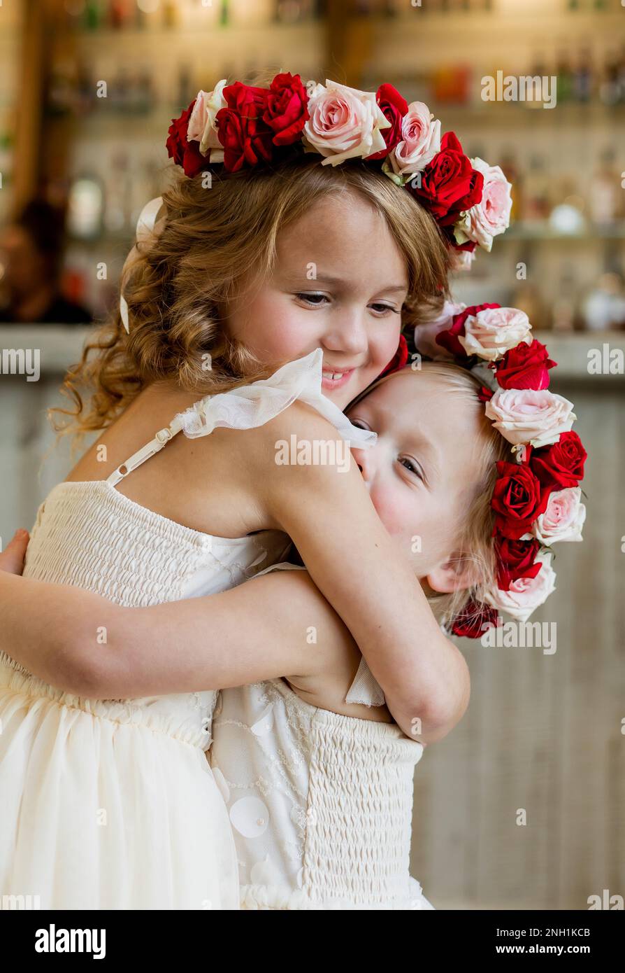 Flower girls hugging on wedding day Stock Photo